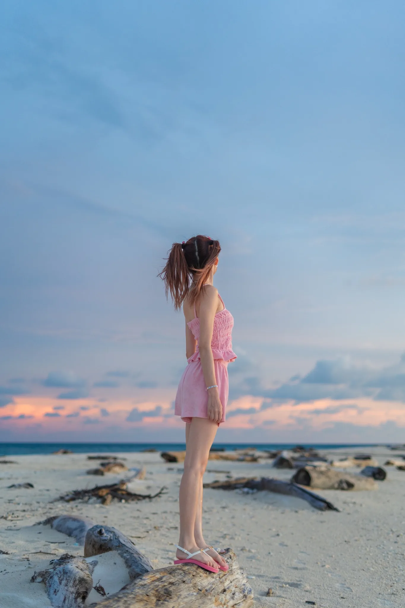 Wingkeh watching a pastel sunset at a beach
