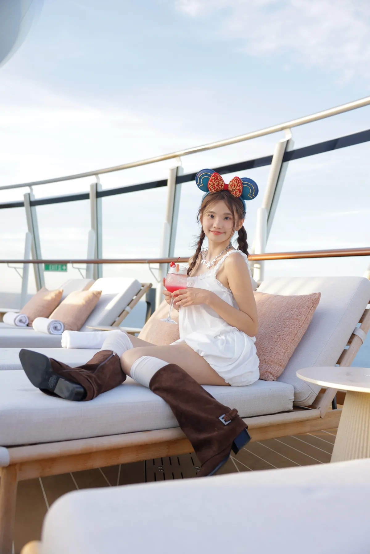 Wingkeh relaxing on a cruise ship with a drink
